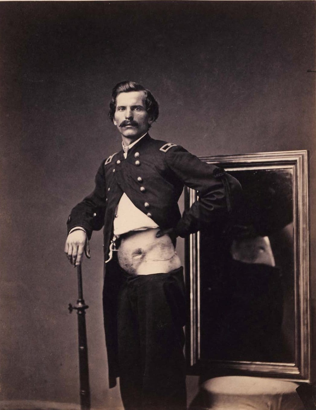 Photograph of injured Civil War soldier in front of a mirror