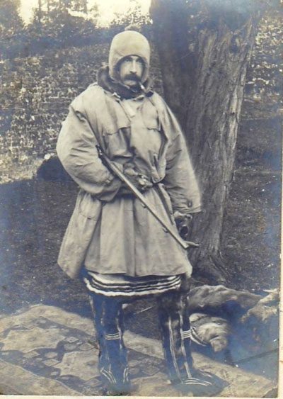 Reginald Koettlitz in northern polar attire with pipe and gun as used on Jackson-Harnsworth Expedition