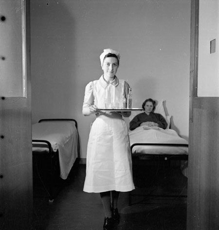 Nurse in uniform by photographer: Richard Stone. This is photograph D 12809 from the collections of the Imperial War Museums. 