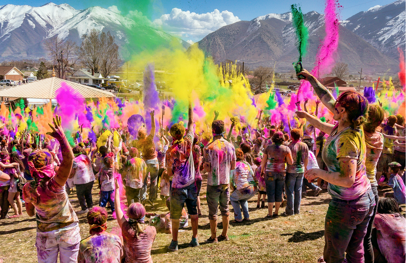 people throwing brightly colored dust in celebration