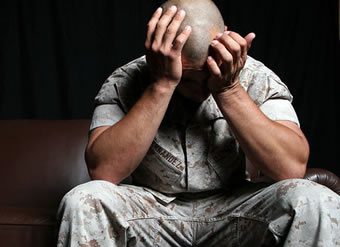 Marine holding head in hands