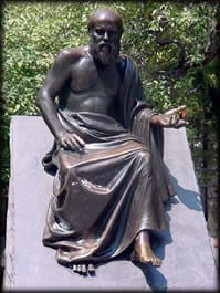 Bronze statue of Socrates seated with questioning gesture