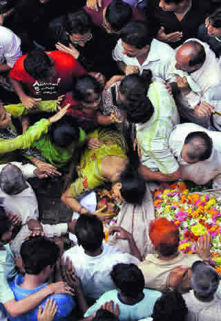 Relatives and neighbors mourn the death of a loved one at a funeral in Mumbai, India.