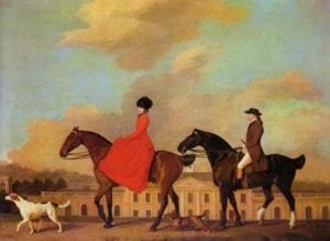 Woman and men riding horses with a dog in the lead