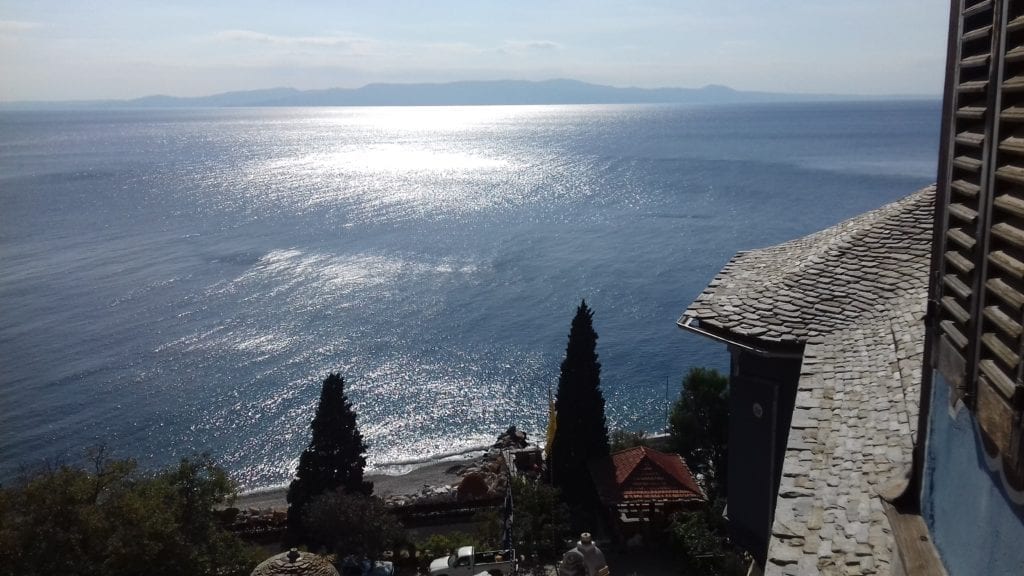 A view of the ocean. Light reflects on the surface. Taken in Greece where the author treated patients.