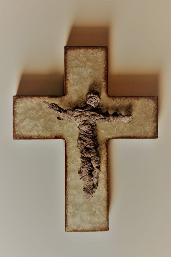 A human figure on a wooden cross