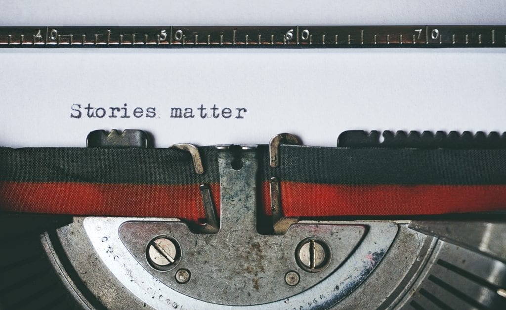 A typewriter showing the text "stories matter" 