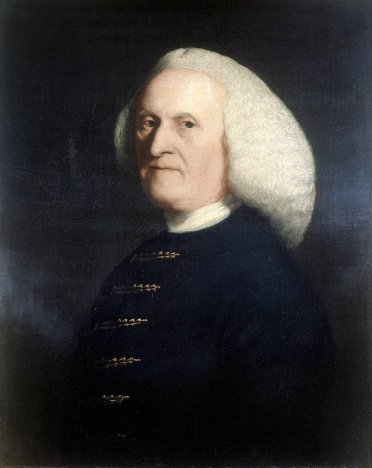 Portrait of William Hunter, a man in a dark blue coat with gold accents and with white puffy hair against a dark blue background