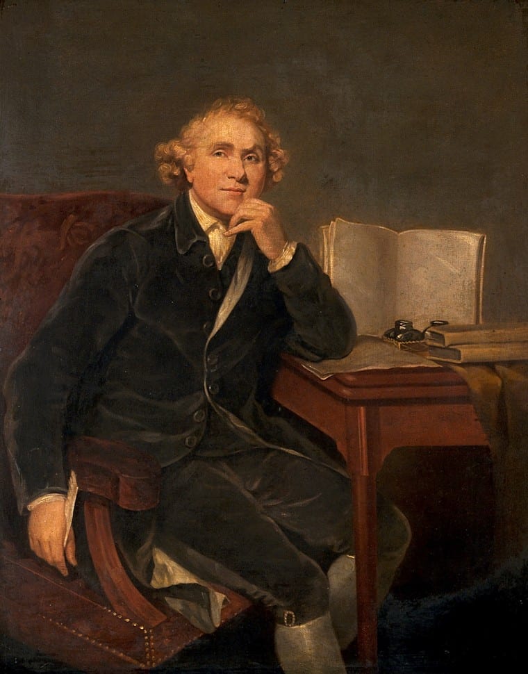 John Hunter (1728–1793), surgeon and anatomist. Depicts a man sitting with his hand against his chin, looking up off to the left with a thoughtful and almost amused look on his face. He is holding a quill in his other hand and has papers, an inkwell, and books on the table next to him.