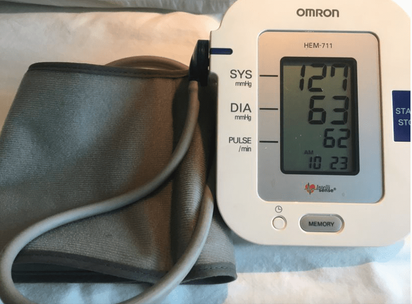 A digital blood pressure machine displaying the blood pressure 127 over 63 and the pulse 62