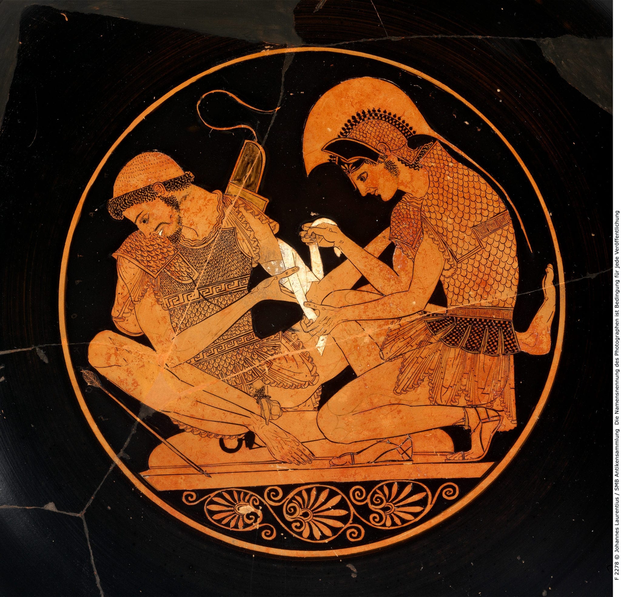 Illustration on the interior of a Greek kylix, Achilles dressing the wounds of Patroclus, central figures in the Iliad