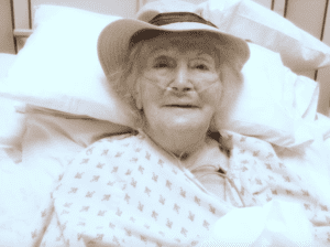 Older woman smiling in a hospital bed