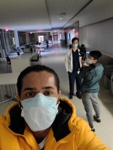 A selfie showing three medical students in masks filming at night for "Stay Inside: A Toast to the Frontline".