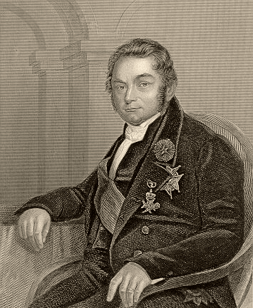 A seated man with short hair and sideburns looking off to the viewer's right, wearing a suitcoat and various medals.
