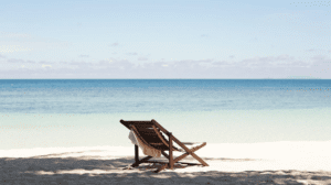 A single beach chair facing the ocean